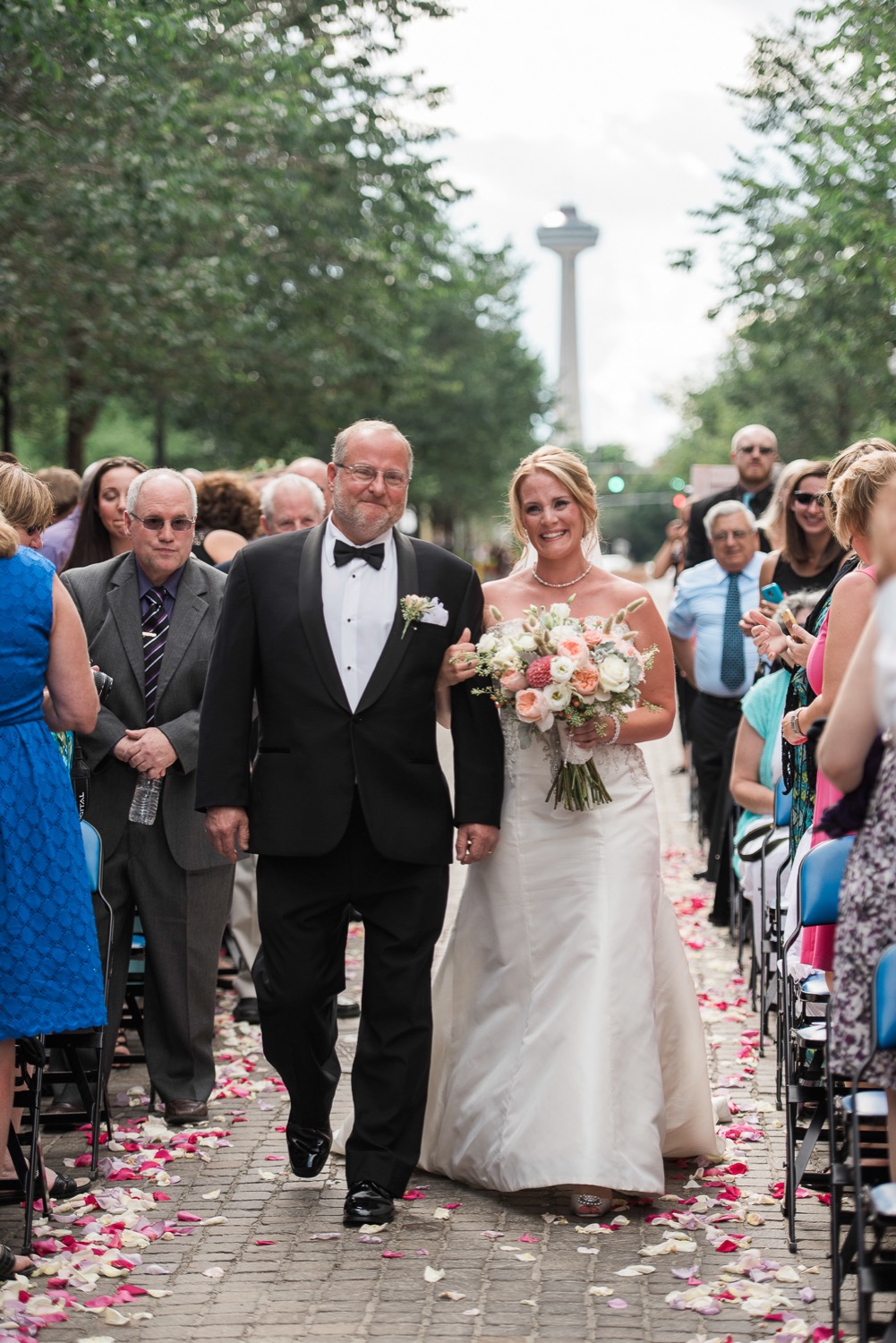 A bride walks down the aisle with her dad in Niagara Falls, NY